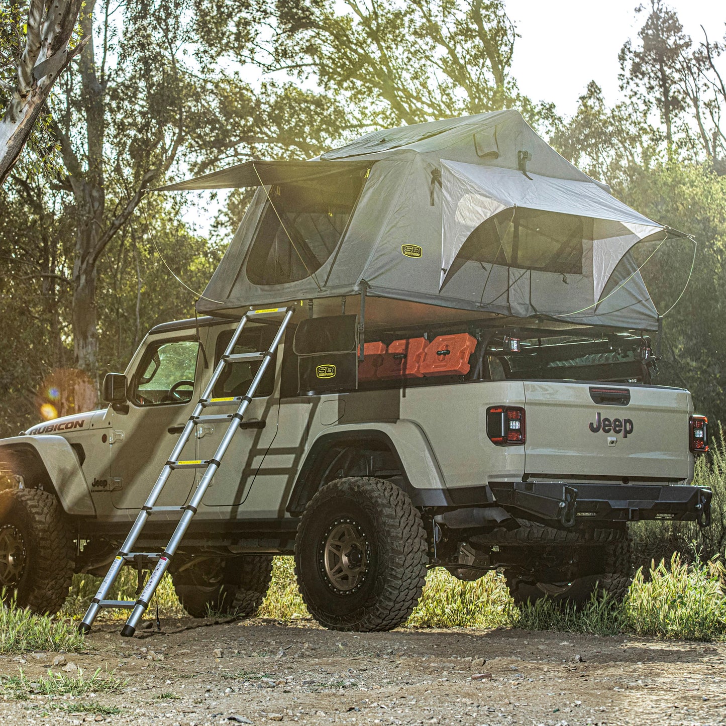 Smittybilt Gen2 Overlander Tent fully deployed on SUV at campsite, adventure-ready rooftop camping gear