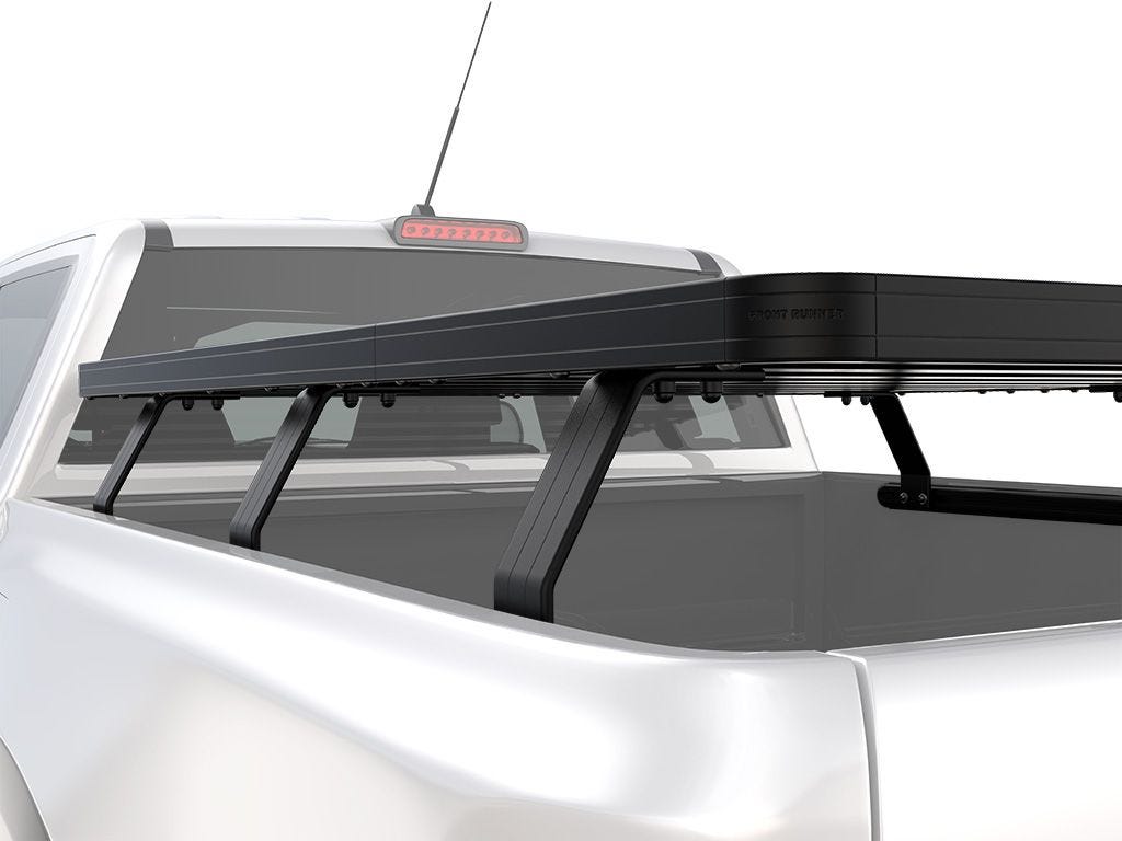 Side angle view of FrontRunner Slimline 2 Full Truck Bed Rack Kit mounted on Chevrolet/GMC pickup, emphasizing low-profile modular design for overlanding