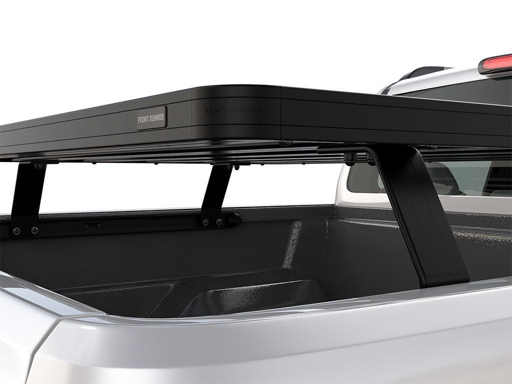 Side close-up of FrontRunner Slimline 2 Full Truck Bed Rack Kit mounted on Toyota truck, showing rugged support legs and modular rooftop tent-ready system