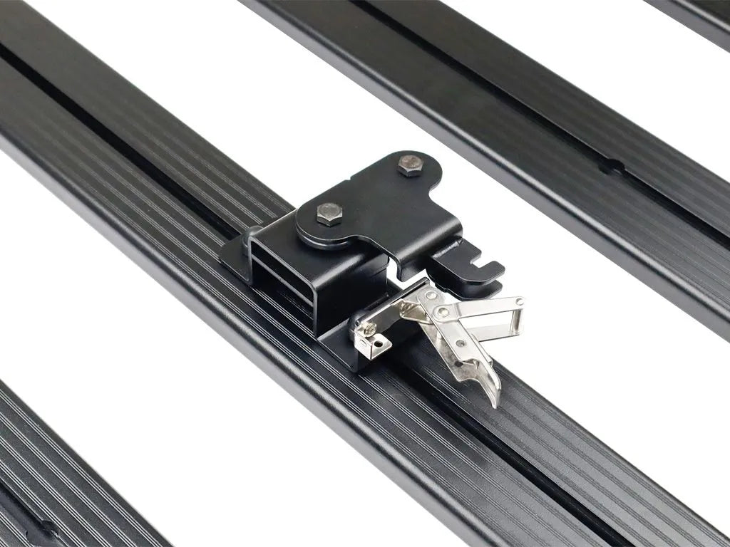 Close-up of FrontRunner Quick Release Tent Mount Kit lockable latch mounted on roof rack, highlighting heavy-duty construction for secure rooftop tent attachment