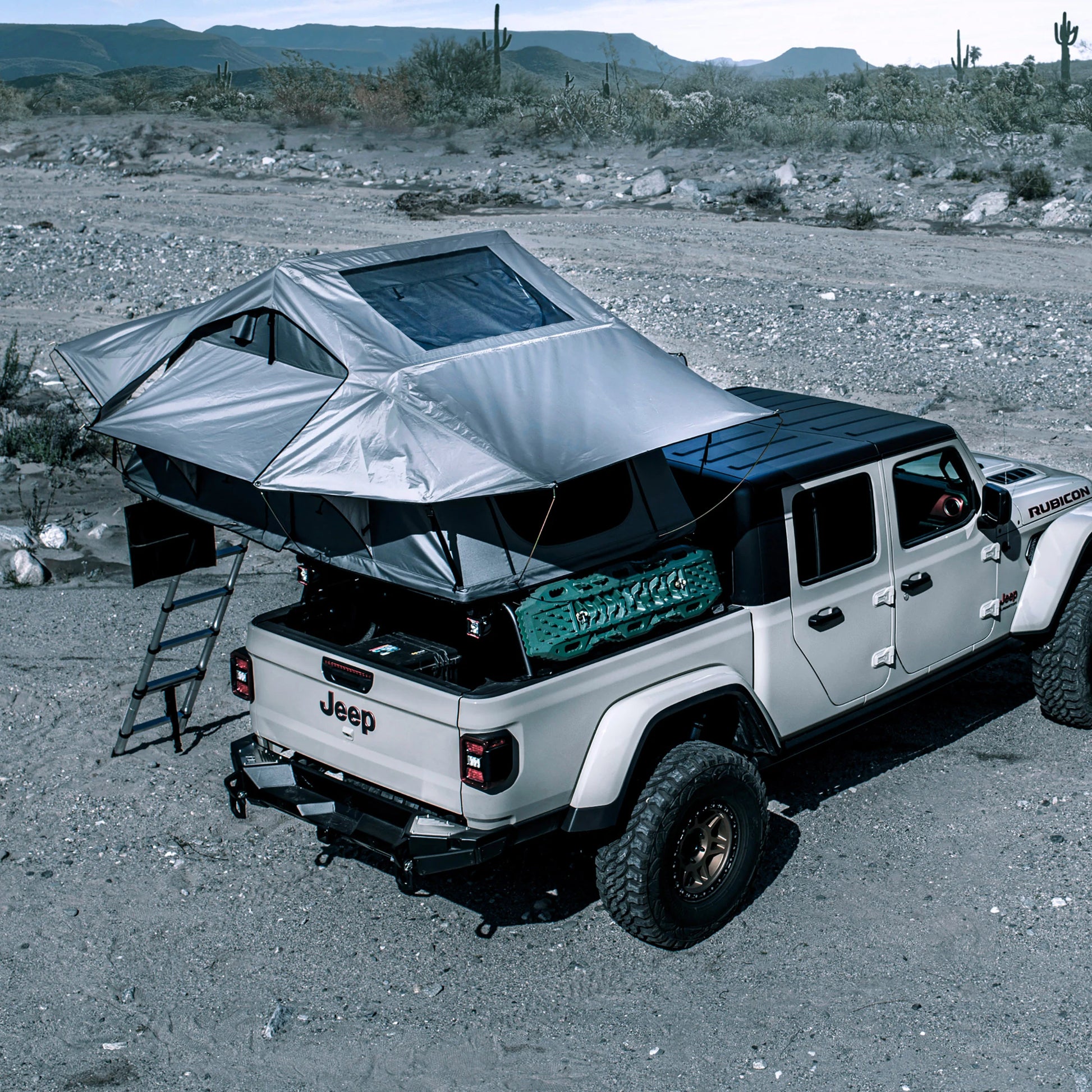 Jeep with Smittybilt Gen2 Overlander Tent deployed at rocky off-road campsite