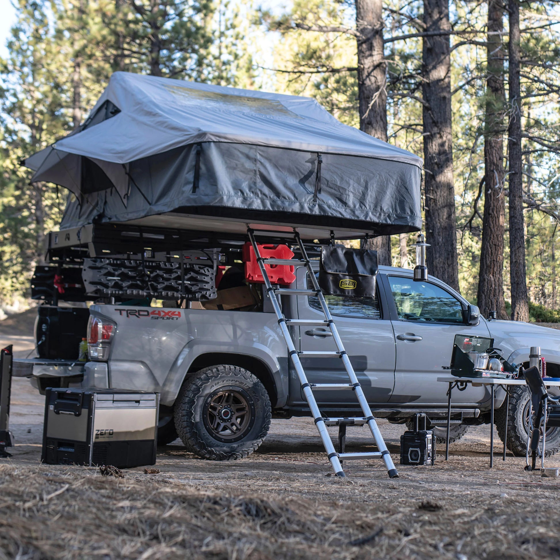 Overlanding vehicle with Smittybilt Gen2 Overlander Tent deployed at campsite, demonstrating spacious rooftop tent for 3-4 campers
