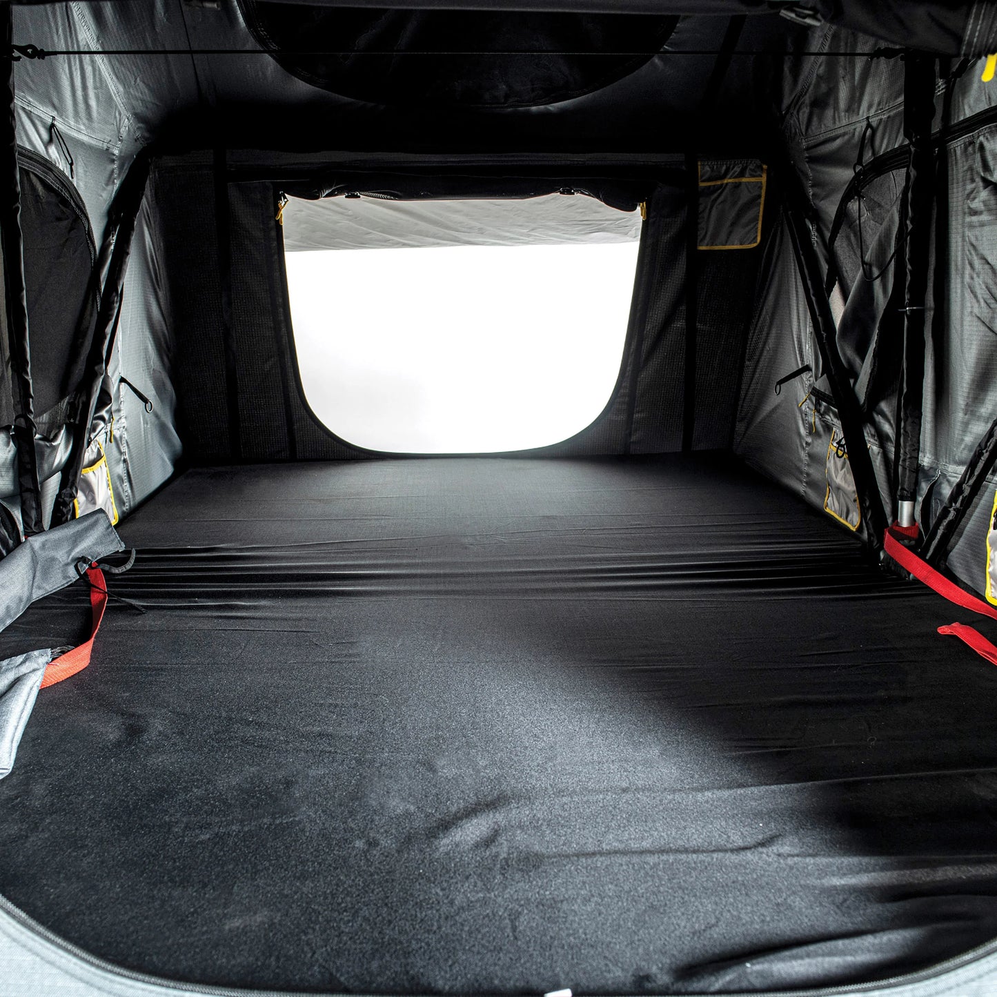 Interior sleeping area of Smittybilt Gen2 Overlander Tent, showing spacious mattress and mesh windows for airflow