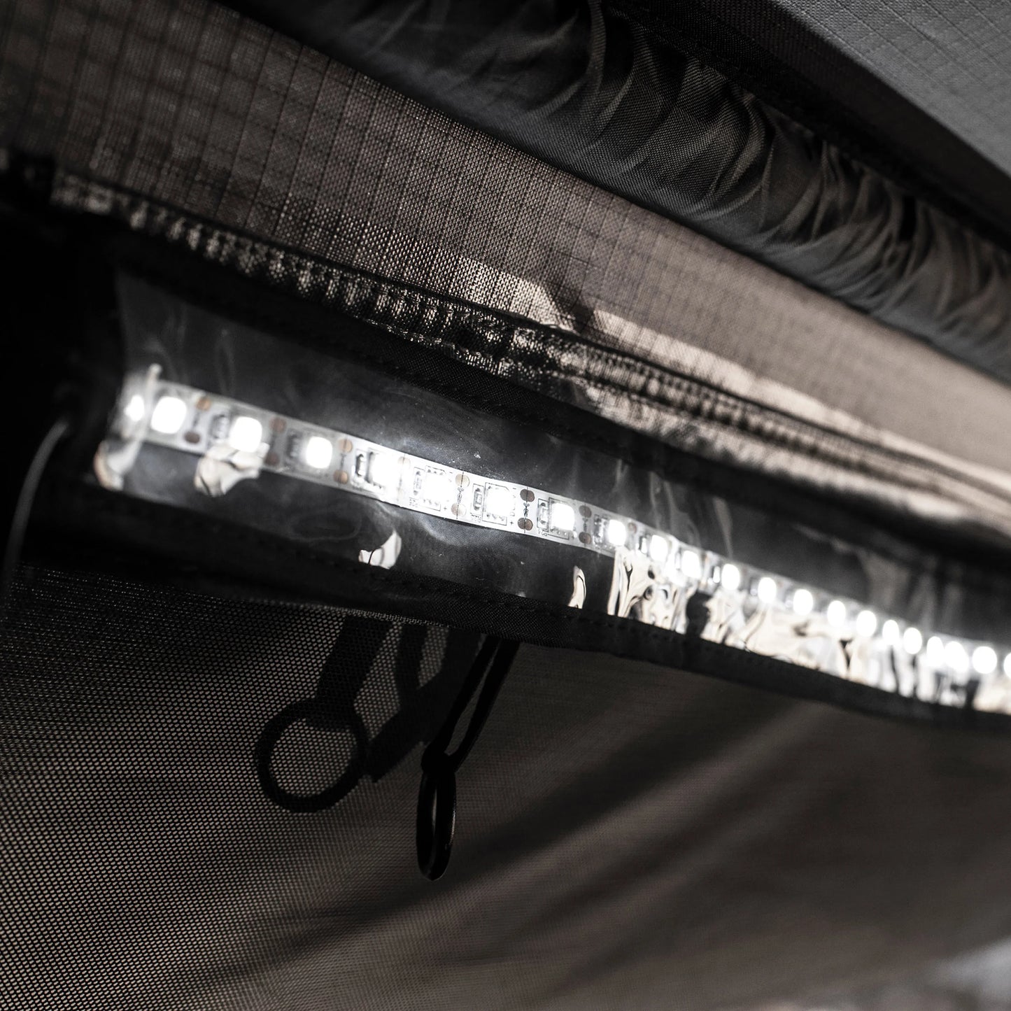 Close-up of Smittybilt Gen2 Overlander Tent’s built-in LED light strip illuminating tent interior