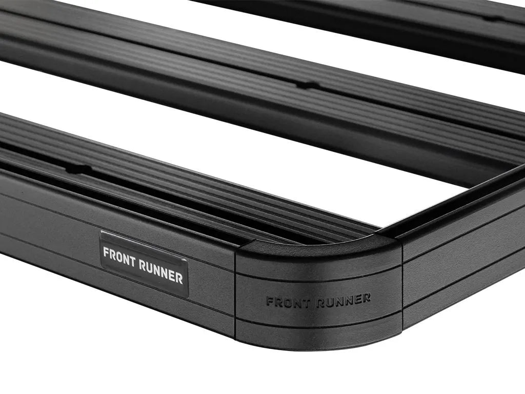 Close-up of FrontRunner Slimline 2 Full Truck Bed Rack Kit corner showing branded plate and rugged modular design for Ram trucks