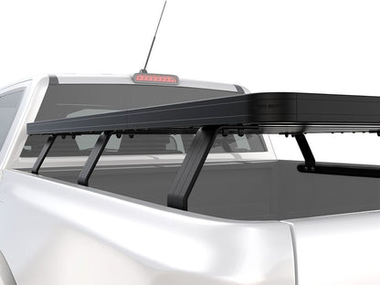 Side angle view of FrontRunner Slimline 2 Full Truck Bed Rack Kit mounted on Chevrolet/GMC pickup, emphasizing low-profile modular design for overlanding