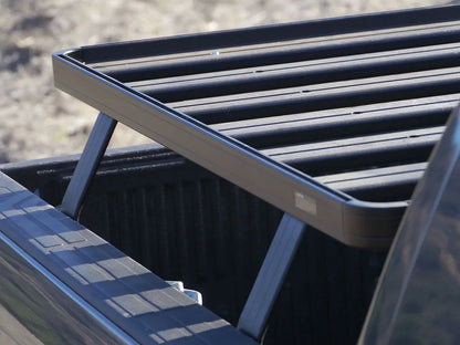 Close-up of FrontRunner Slimline 2 Full Truck Bed Rack Kit slats mounted on Nissan truck, highlighting heavy-duty modular design for rooftop tents