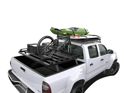 Toyota pickup truck fully outfitted with FrontRunner Slimline 2 Full Truck Bed Rack Kit and rooftop tent, adventure-ready overlanding setup