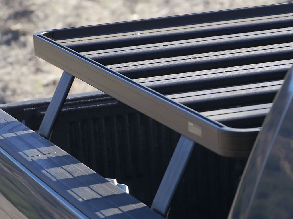 Close-up of FrontRunner Slimline 2 Full Truck Bed Rack Kit slats mounted on Toyota truck, highlighting rugged modular construction for rooftop tents and gear
