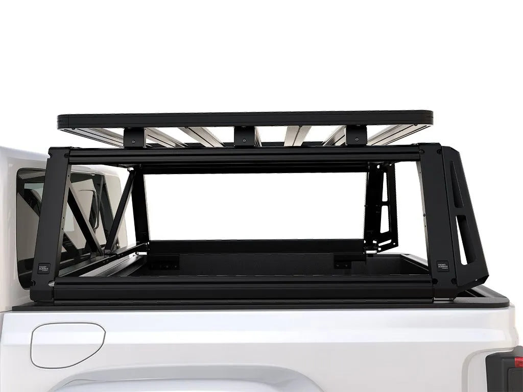 Side profile close-up of FrontRunner Pro Bed Rack Kit mounted on Jeep Gladiator (2019–current), highlighting modular steel rack system with Slimline II Roof Rack platform for rooftop tents and gear