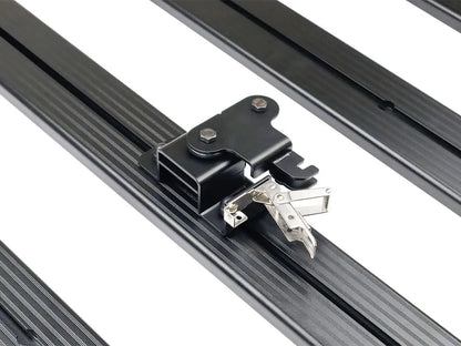 Close-up of FrontRunner Quick Release Tent Mount Kit lockable latch mounted on roof rack, highlighting heavy-duty construction for secure rooftop tent attachment