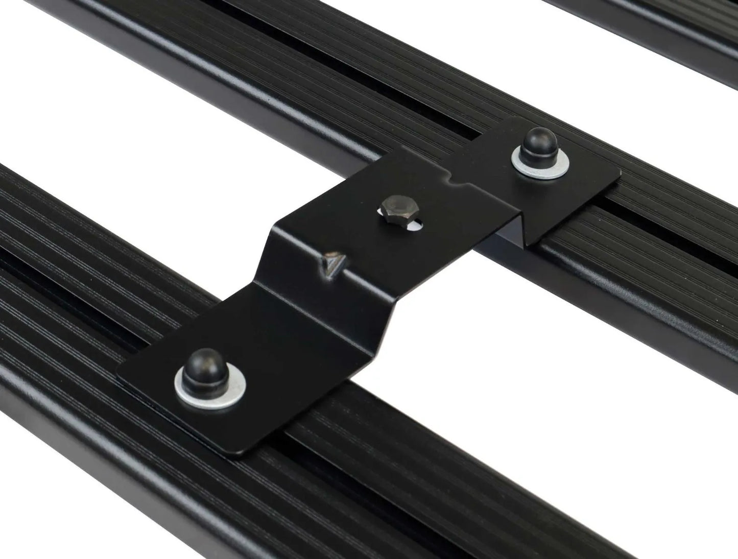 Close-up of FrontRunner low-profile rooftop tent mounting bracket secured to roof rack rail, showcasing durable and rattle-free off-road mounting system