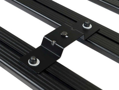 Close-up of FrontRunner low-profile rooftop tent mounting bracket secured to roof rack rail, showcasing durable and rattle-free off-road mounting system